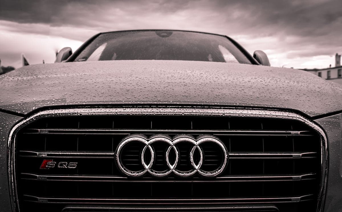 Water beading tightly on a freshly ceramic-coated gloss-black car panel